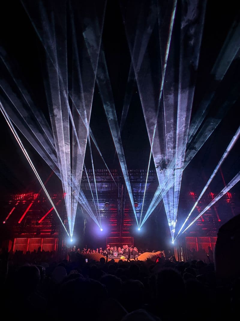 White lasers over a packed New York dance floor